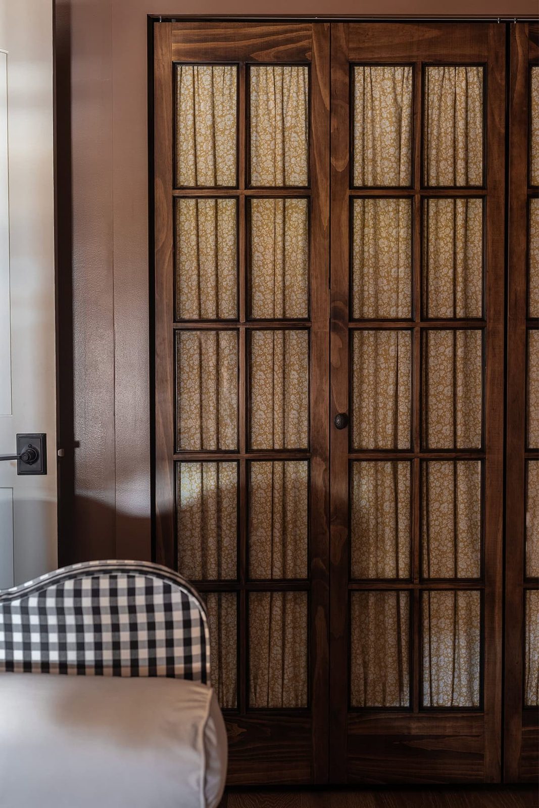 cottage closet with glass french doors and floral curtains