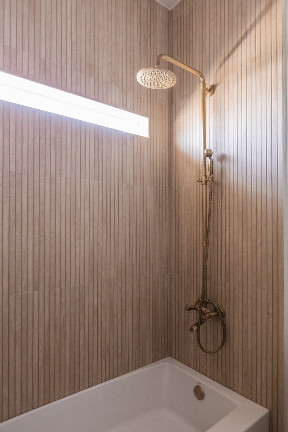 shower with wood look ribbon tile