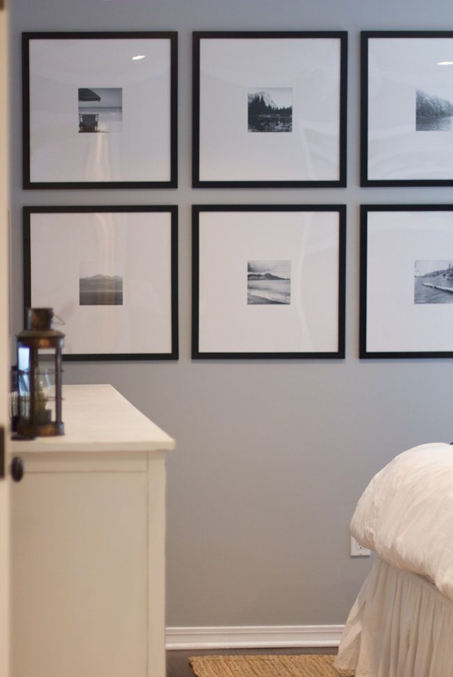 gray wall with black frames and large white mats