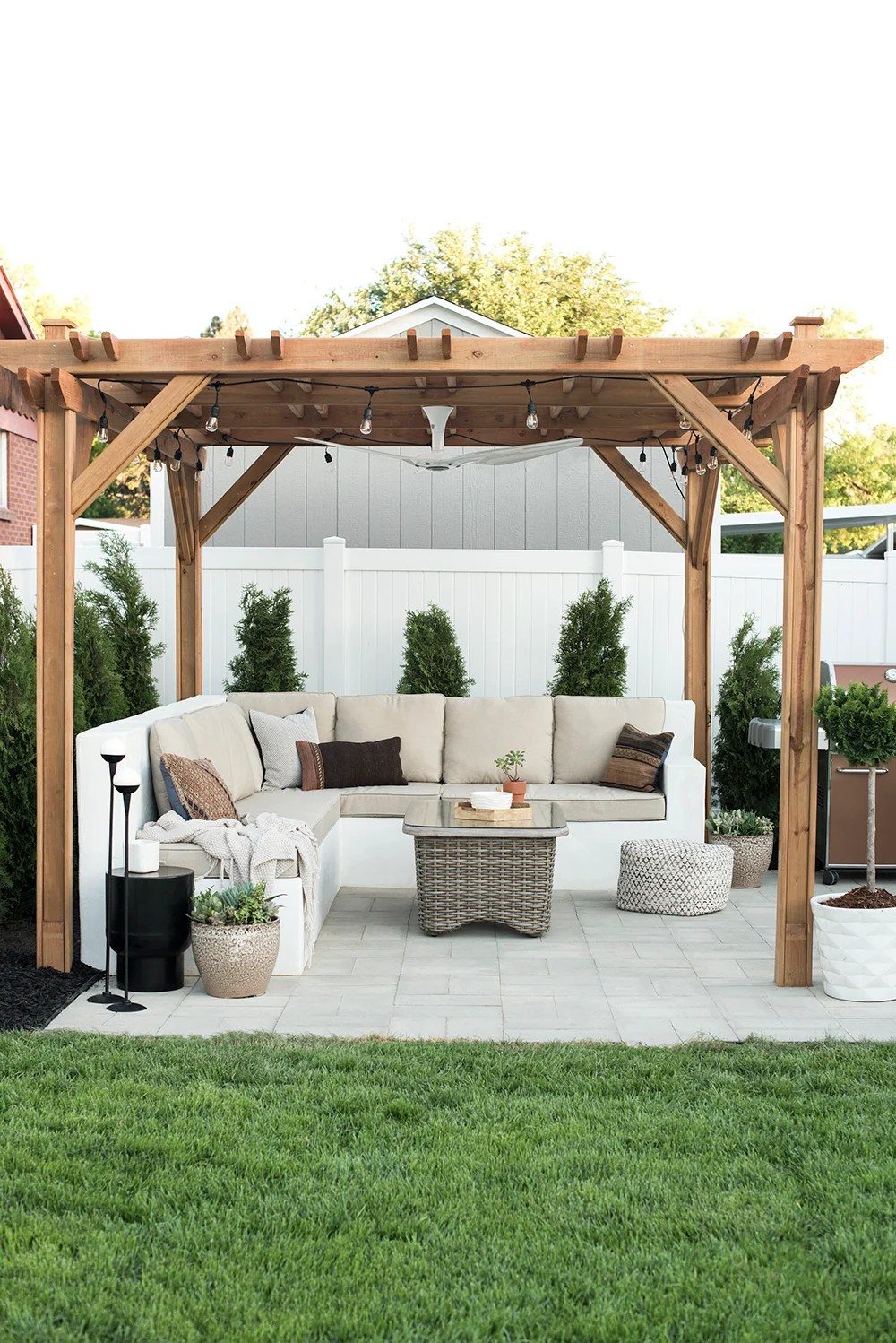 backyard with wood pergola and custom concrete sofa