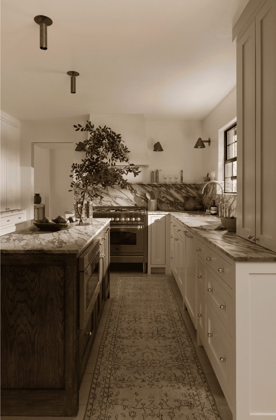 white kitchen with marble backsplash and flush mount lights