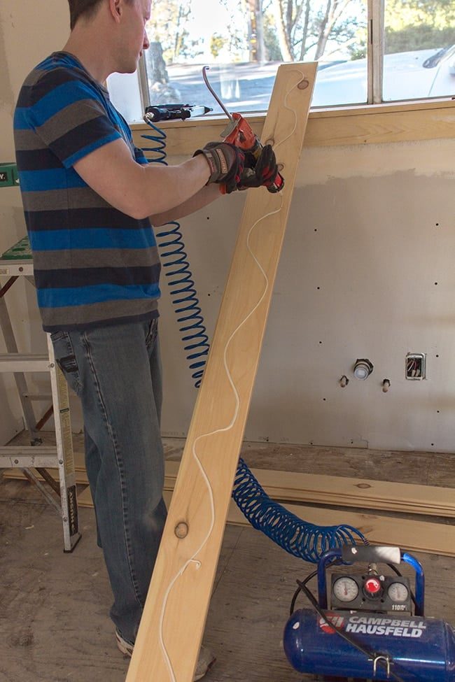 applying liquid nails to back of tongue and groove board