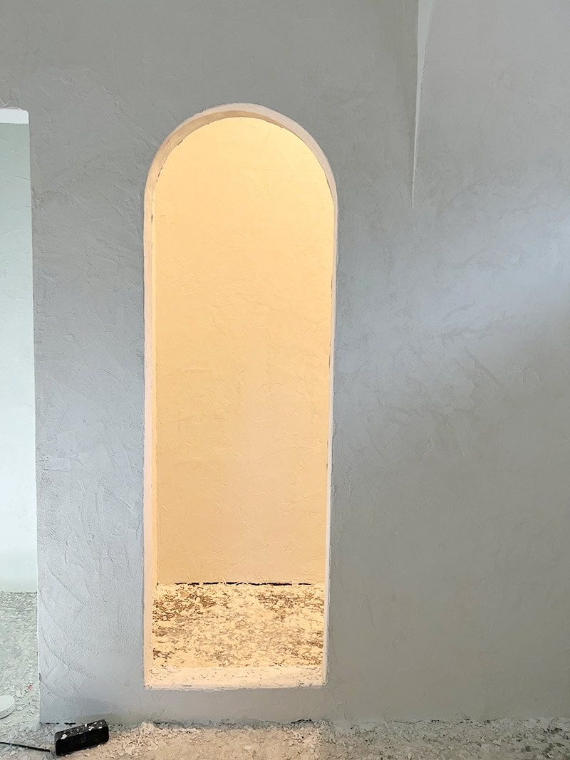 microcement bathroom with arched shower opening