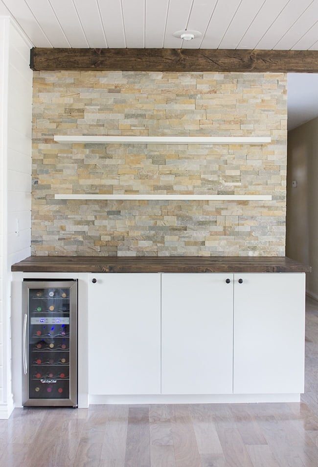 custom built-in bar area with quartz ledgestone, floating shelves, and ikea base cabinets