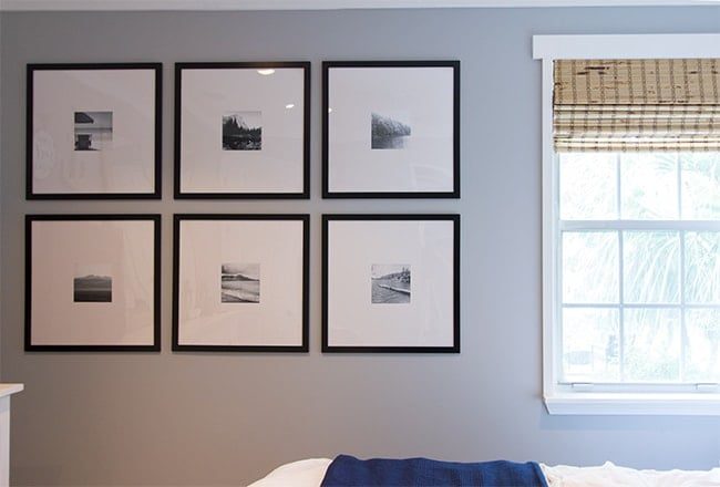 gray wall with gallery wall with black frames and black and white photographs