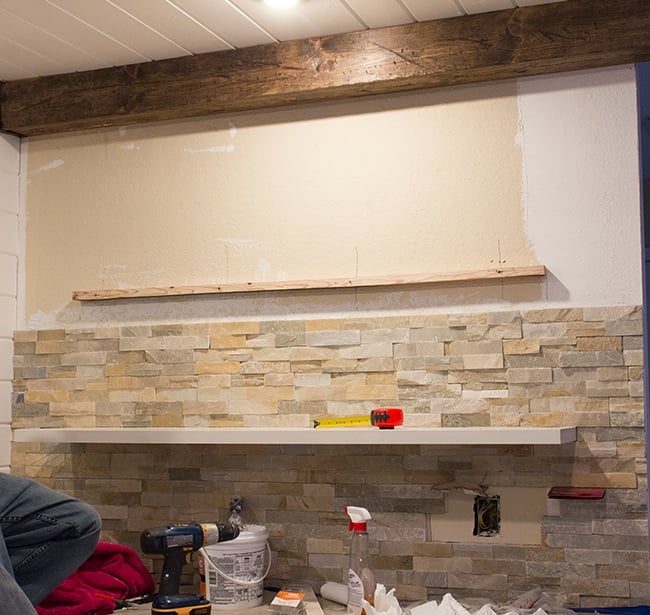 diy quartz ledgestone wall installation with floating shelves