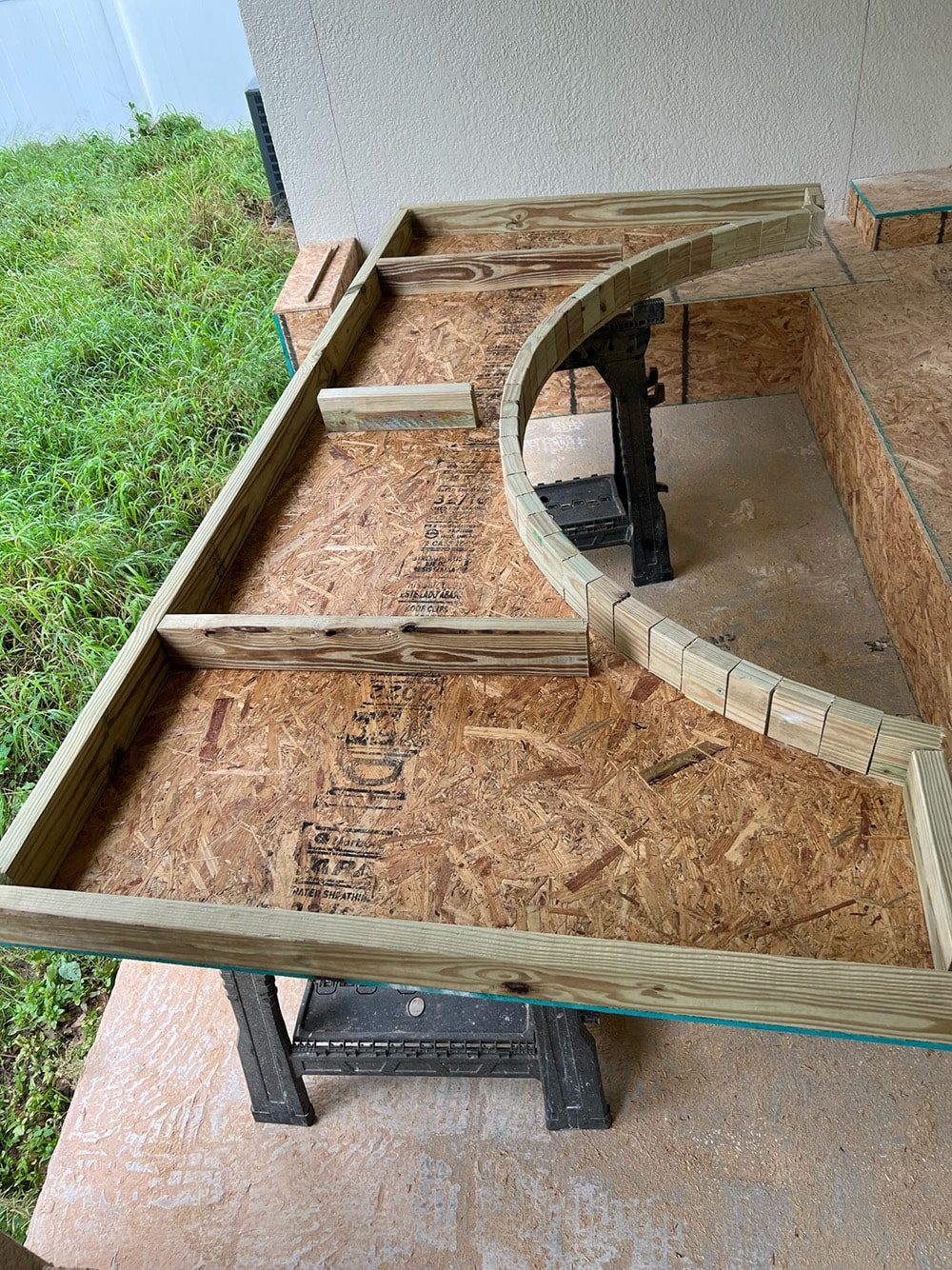 diy custom built in seating with arches on a porch